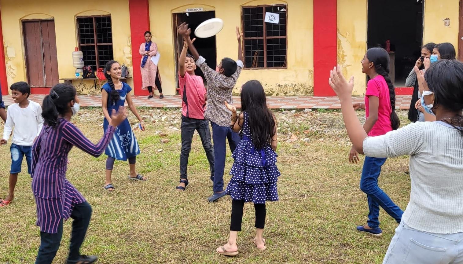 Children gathering on an open field for the first day of play