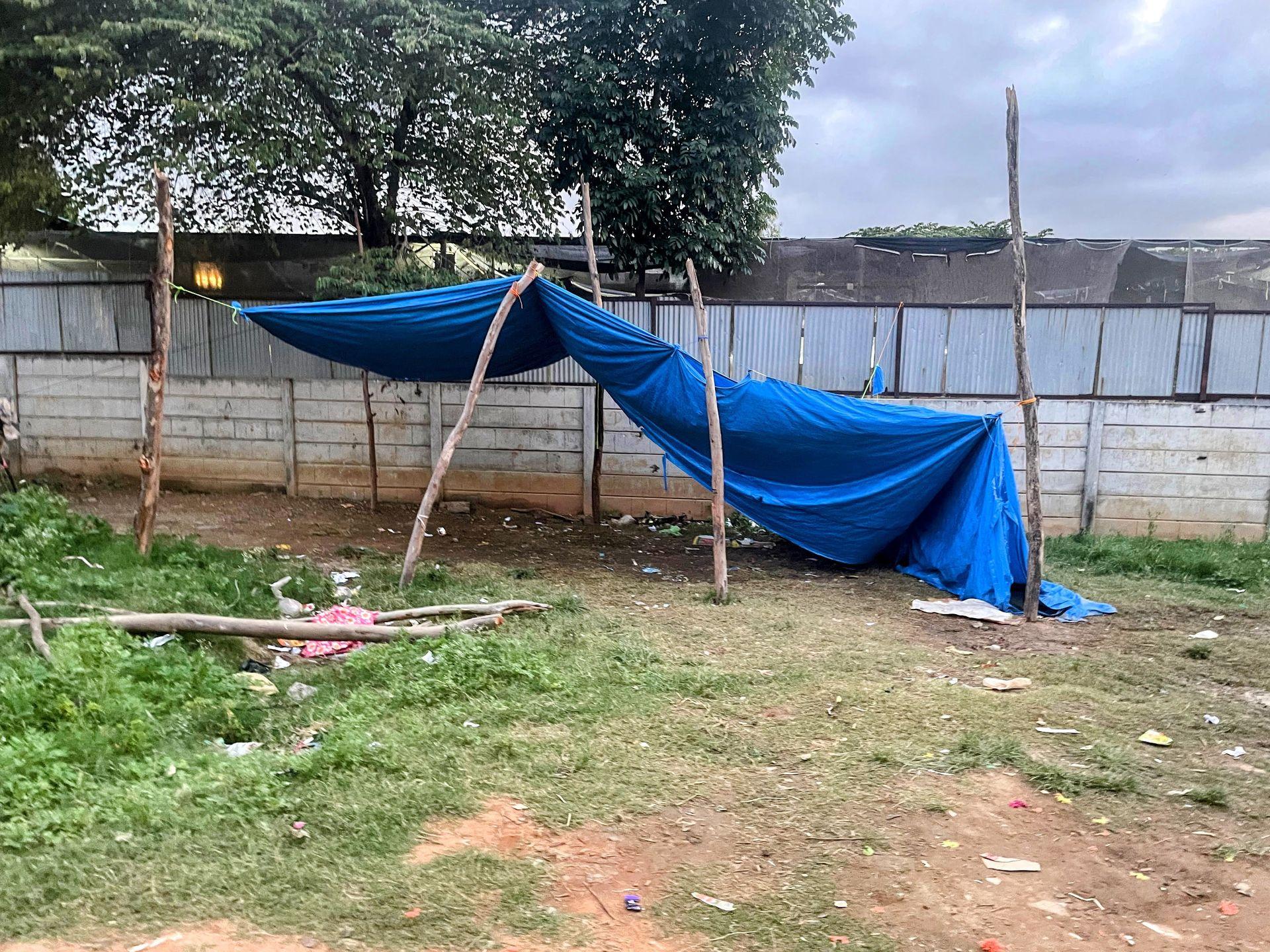 A tarpaulin shelter built over bamboo poles for the classroom